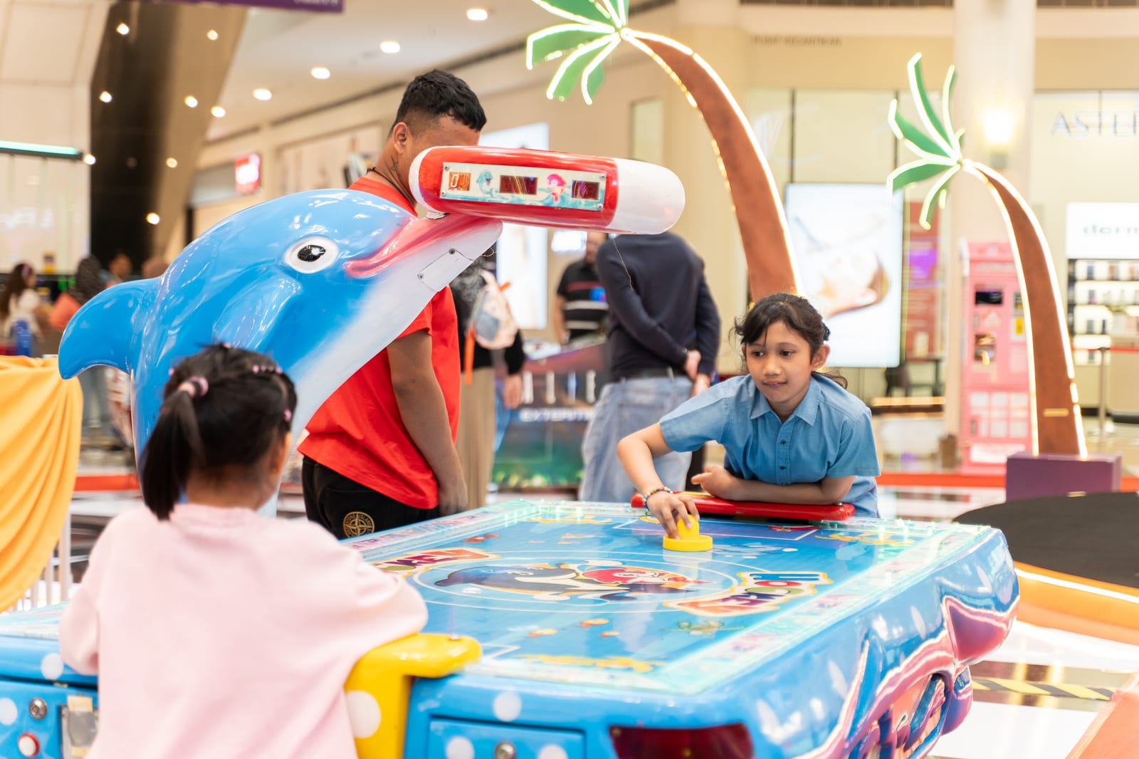 Children playing carnival arcade games at Alamanda VIKids Carnival