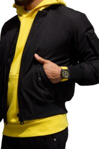 Bell & Ross BR-03 Helipad worn with black jacket and yellow hooded top