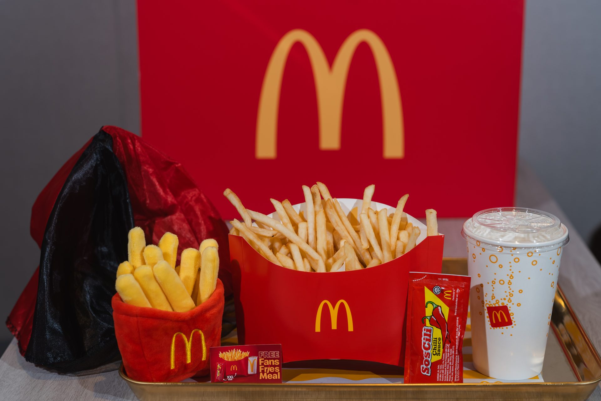 Fans enjoying the McDonald’s Fans Fries Meal with fries-themed plushies
